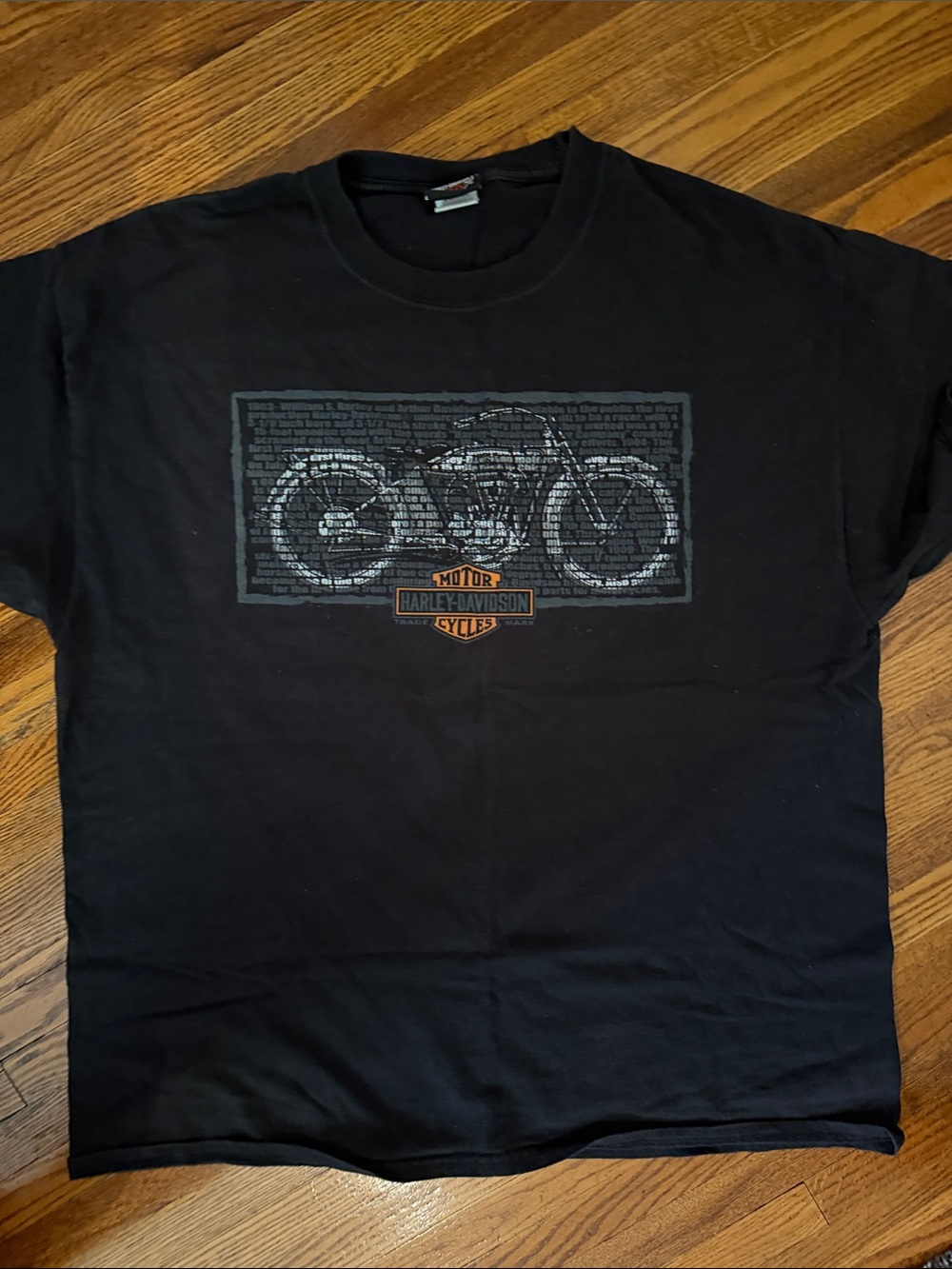 Harley-Davidson Clare”s- Black Tee with Motorcycle Outline and Orange Logo
